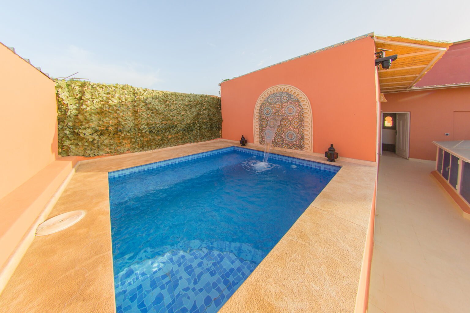 The rooftop pool, rose-pink walls and the Marrakech sky